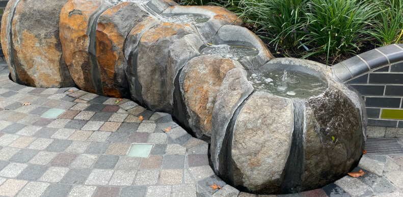 Boulder with water feature